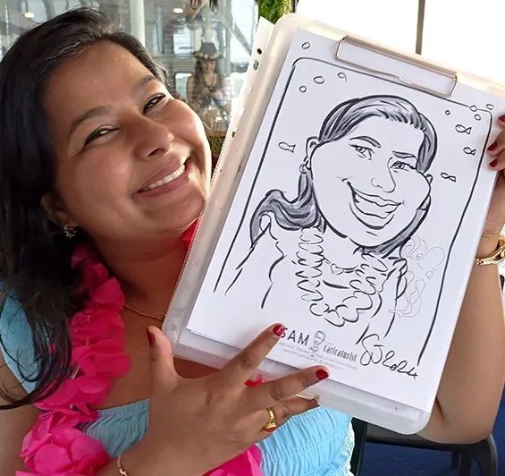 Smiling guest in a pink lei holding her pen and ink caricature